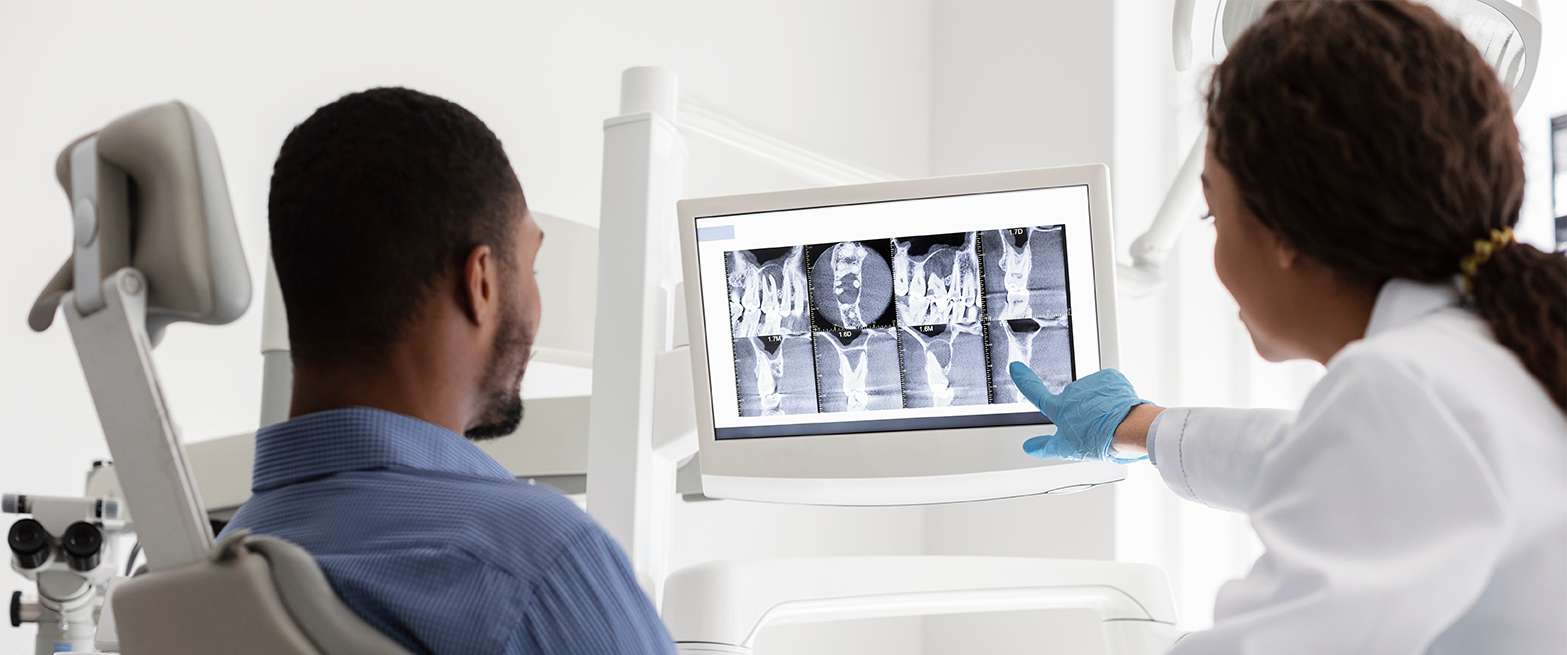 adult patient and consultant discussing the teeth xray and alignment solutions