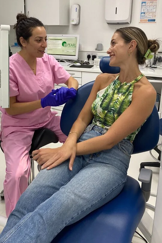 Dr Edina in our dental practice in London, having a chat with a patient